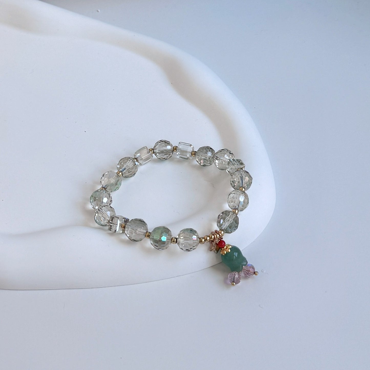 A cute bracelet with glass beads and a green flower charm, the perfect gift for girlfriend, gift for sister, gift for daughter, gift for wife, or gift for friend.