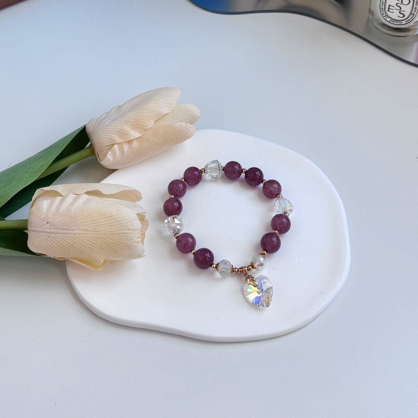 A cute bracelet with plum-hued strawberry quartz beads and a Swarovski heart charm, perfect as a gift for girlfriend, gift for sister, gift for daughter, gift for wife, or gift for friend.