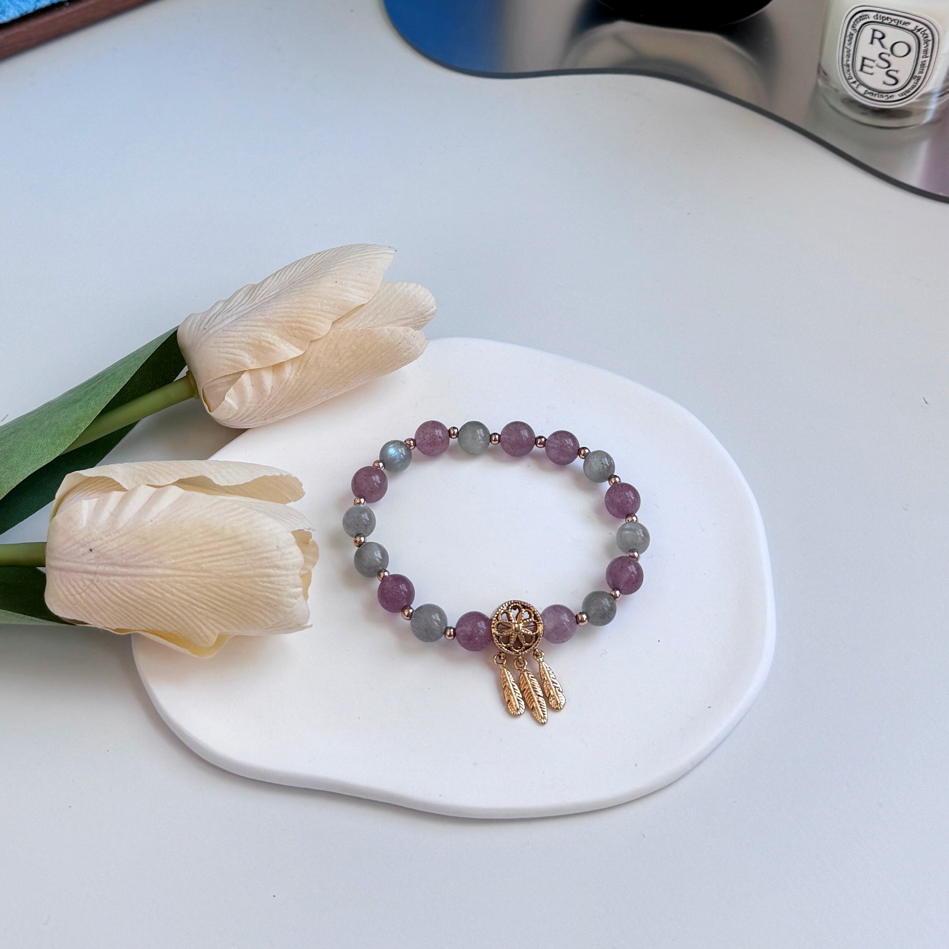 Strawberry quartz and moonstone bracelet with golden accents.