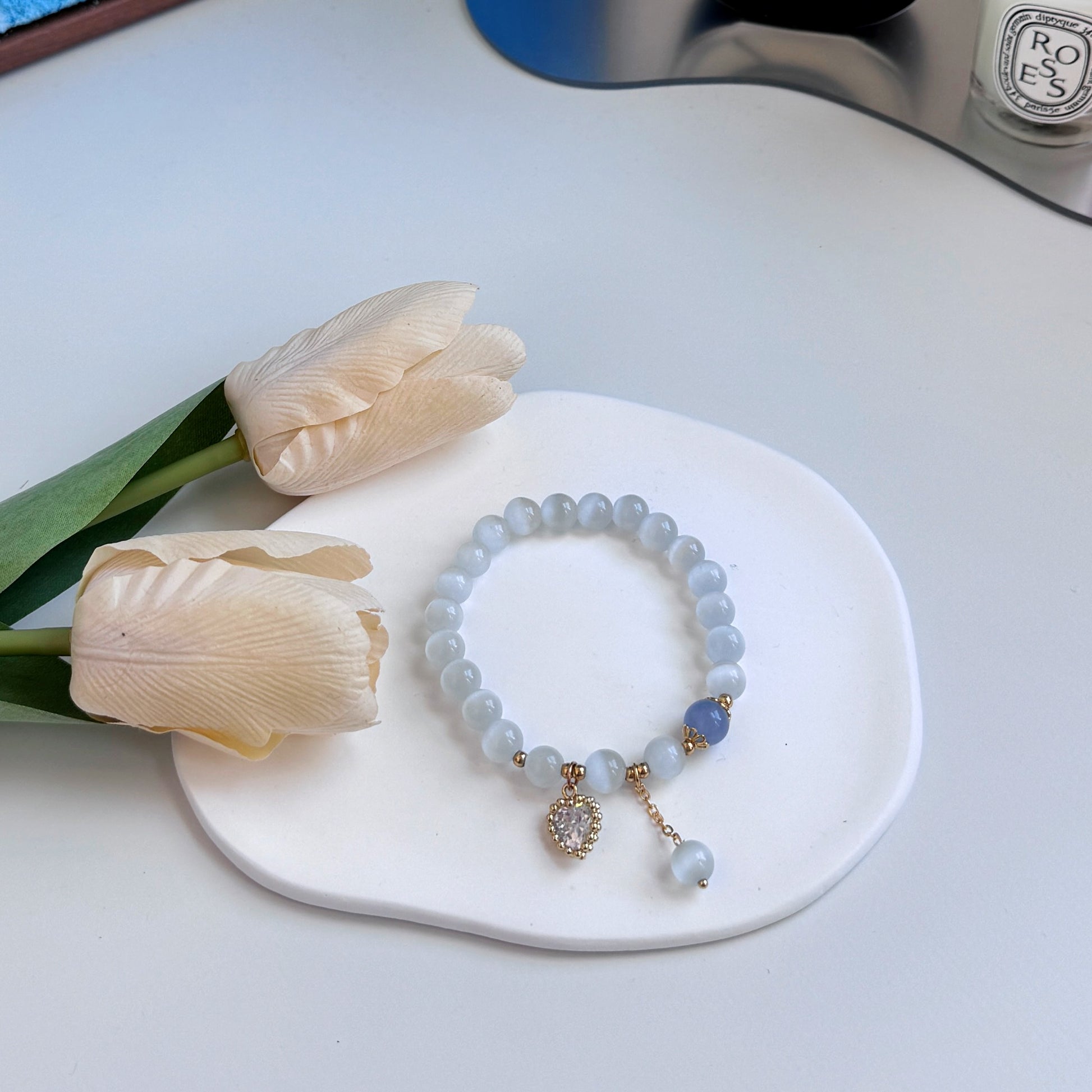 A cute bracelet with light blue aquamarine beads, a royal blue bead, and a heart charm, ideal as a gift for girlfriend, gift for sister, gift for daughter, gift for wife, or gift for friend.