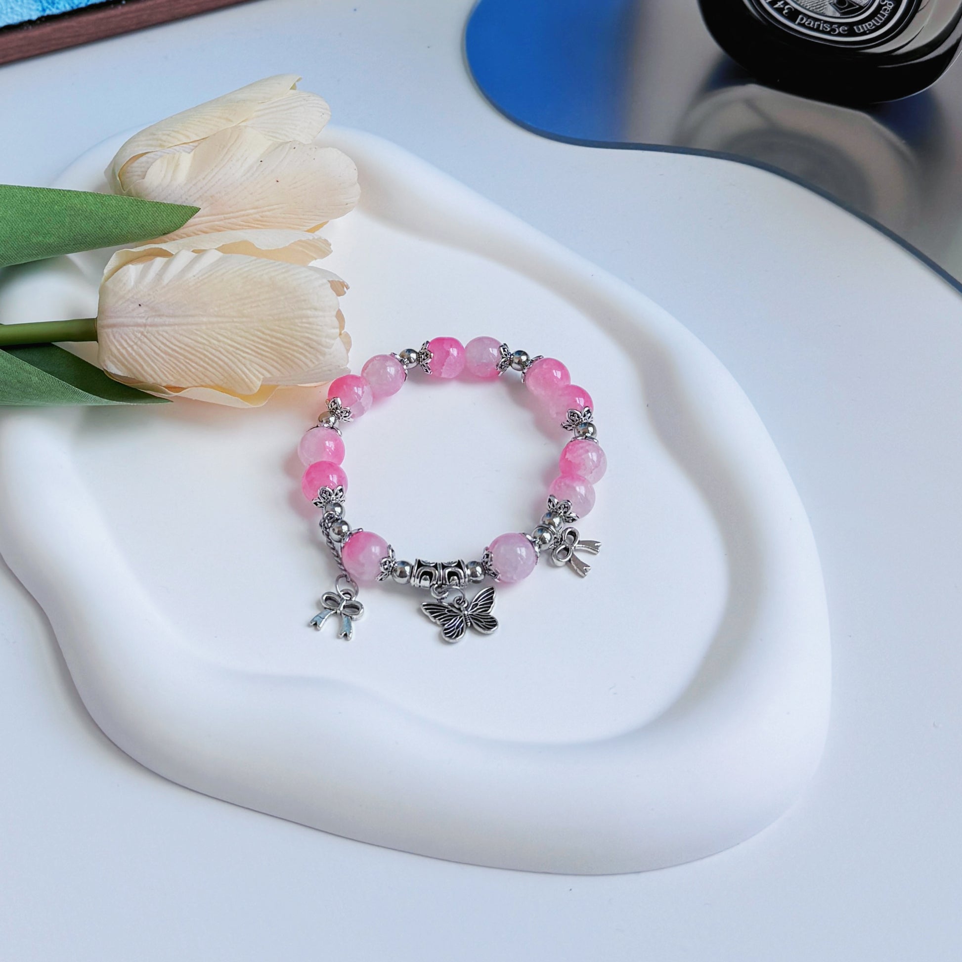 A shining pink bracelet with metal accents.