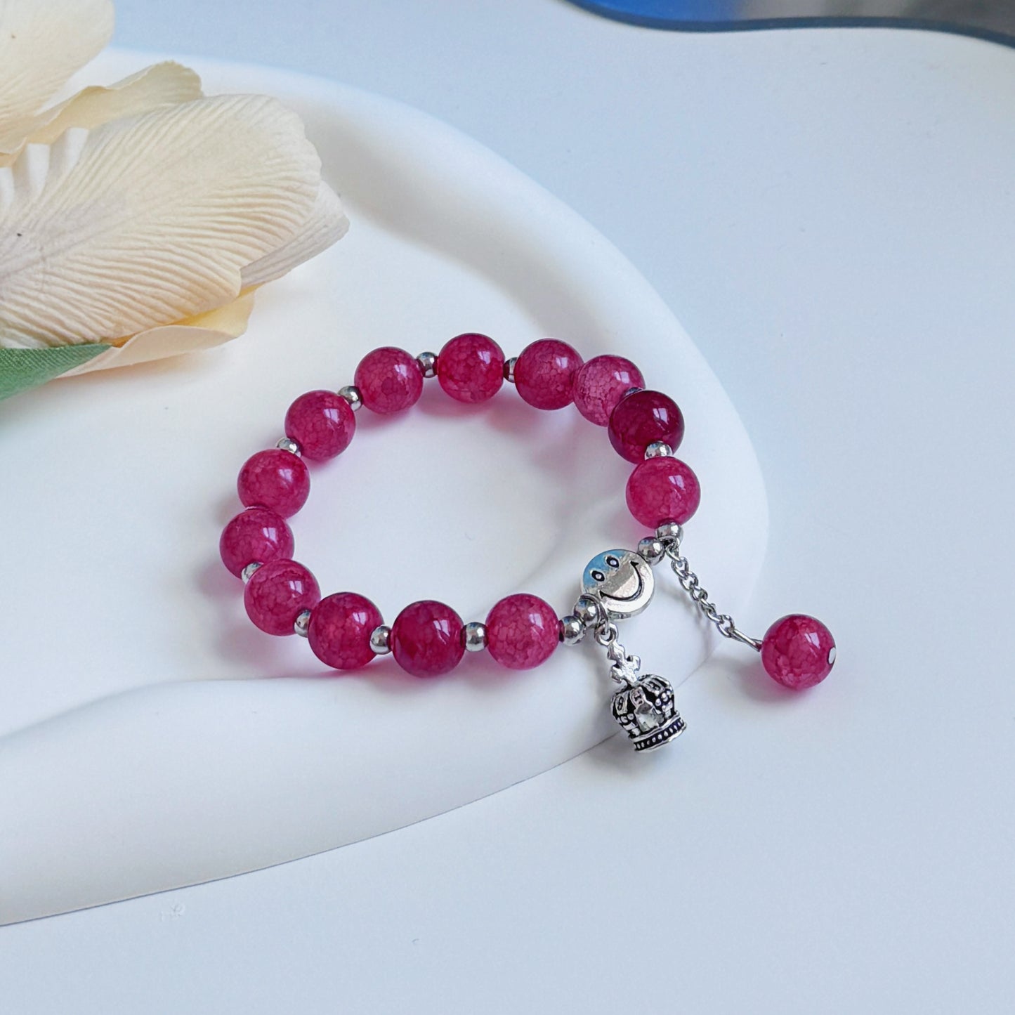 A bright red glass beaded bracelet.