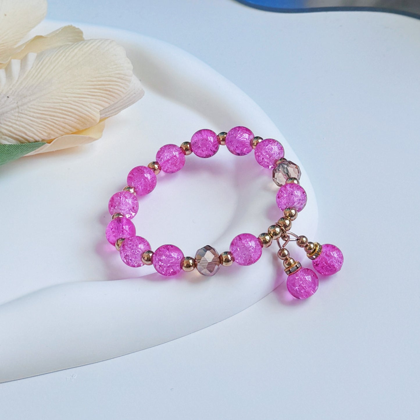 A cute, simple, and delicate hot pink bracelet, a piece of jewelry for young women to wear.