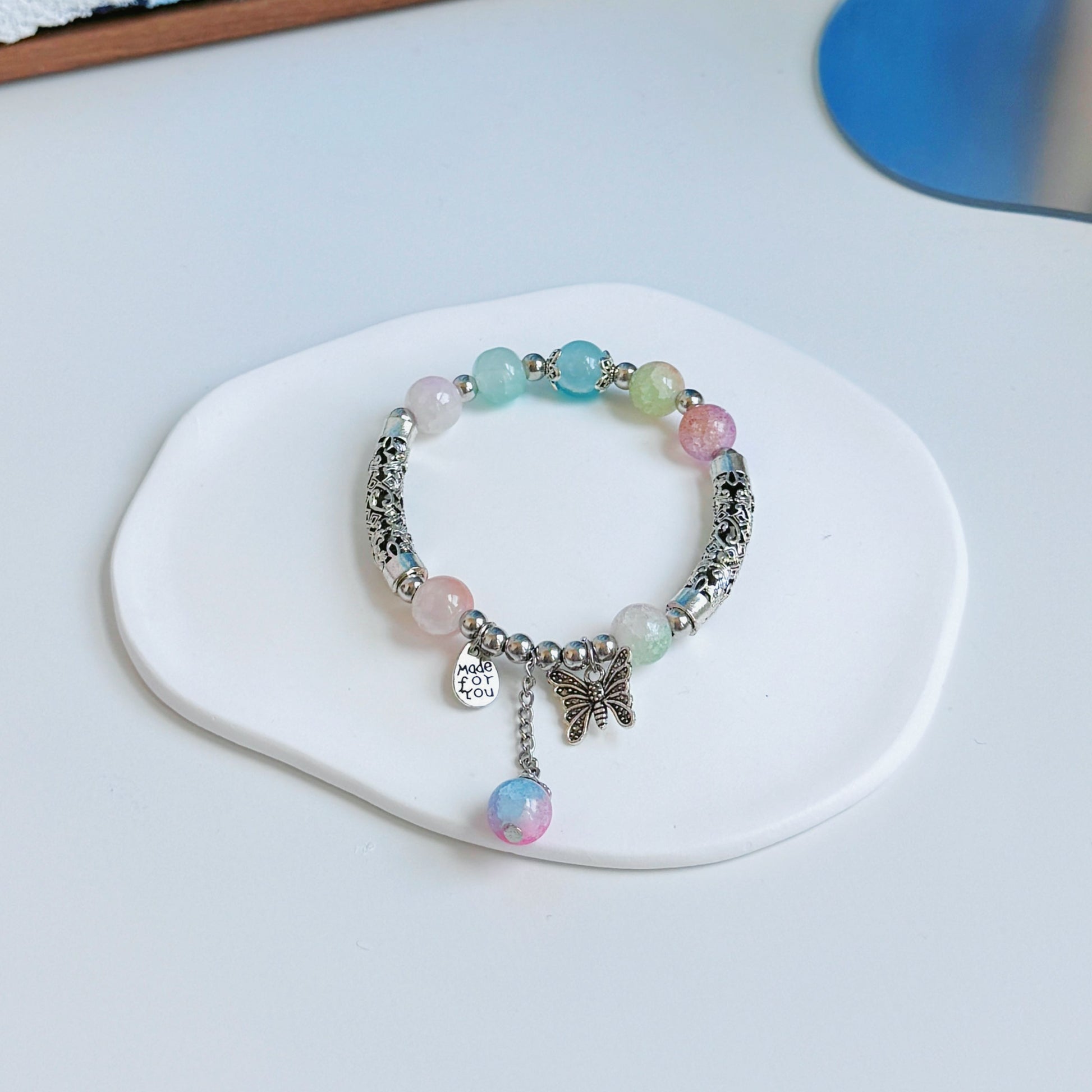 A simple, cute bracelet with multicolored glass beads, the colors of a hazy dream.