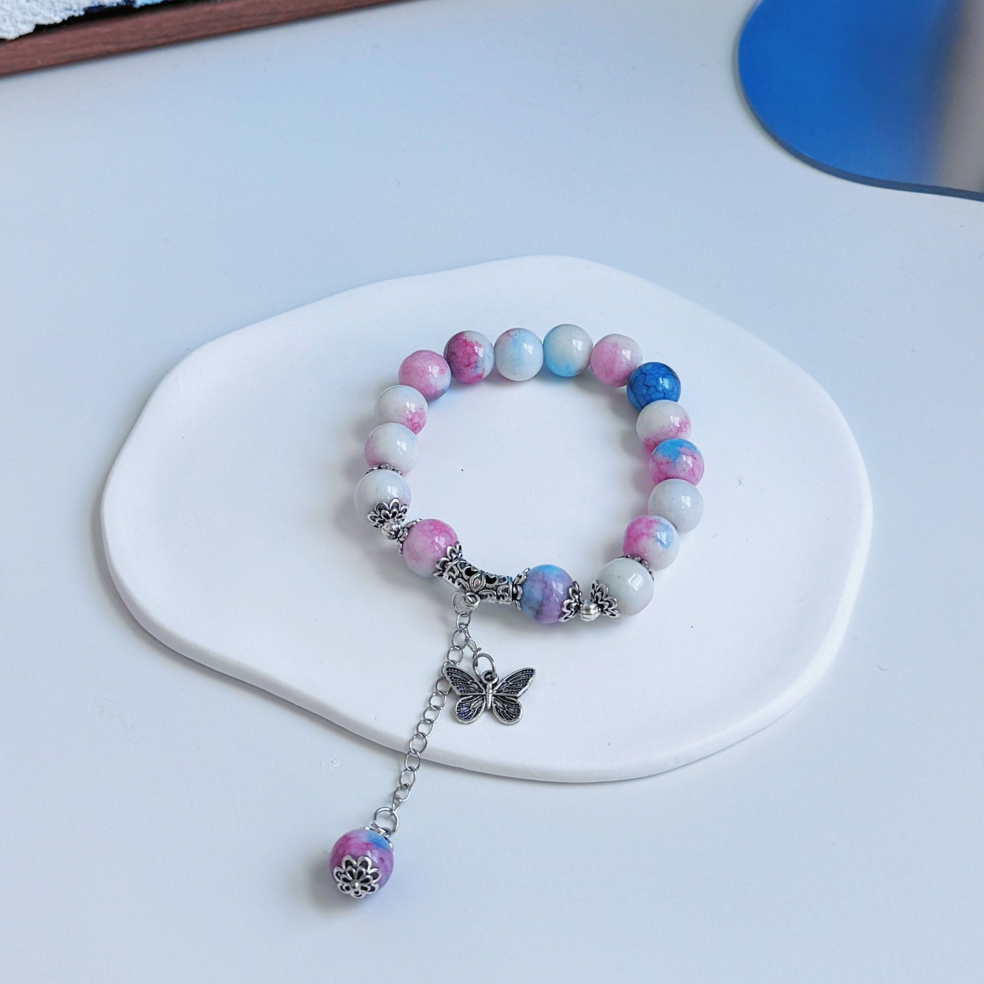 A simple, cute bracelet with pink, blue, and white glass beads, a dreamy accessory for any fashionable and stylish outfit.