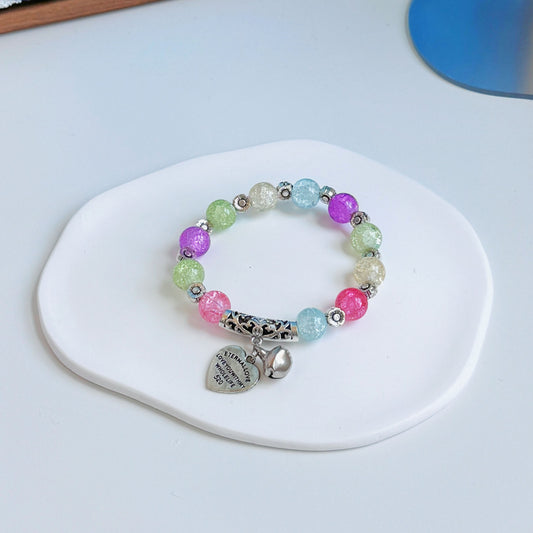 A simple, cute bracelet with multicolored glass beads, all of the colors of a flowery field in a lively meadow.