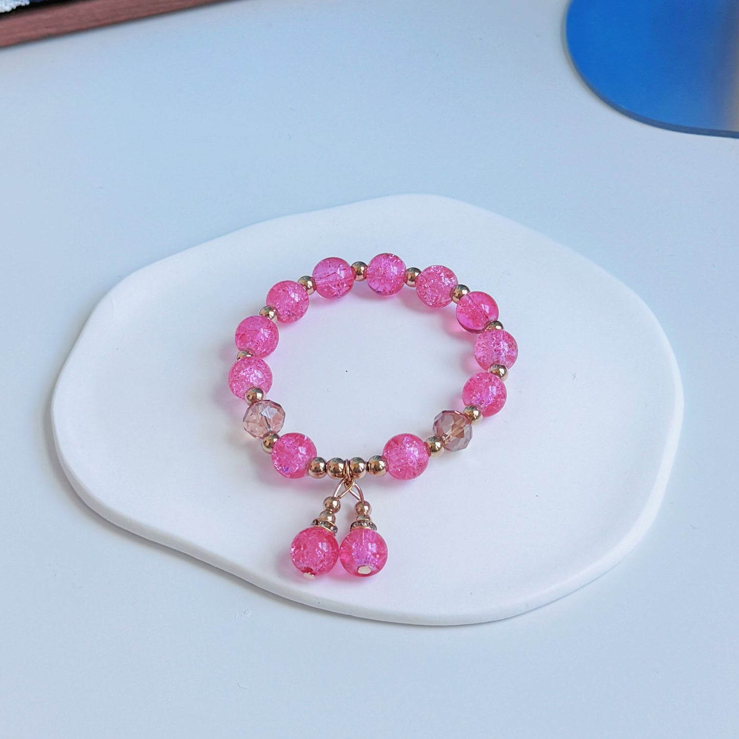 A simple, cute bracelet with bright hot pink glass beads, a simple and pretty addition to any outfit.