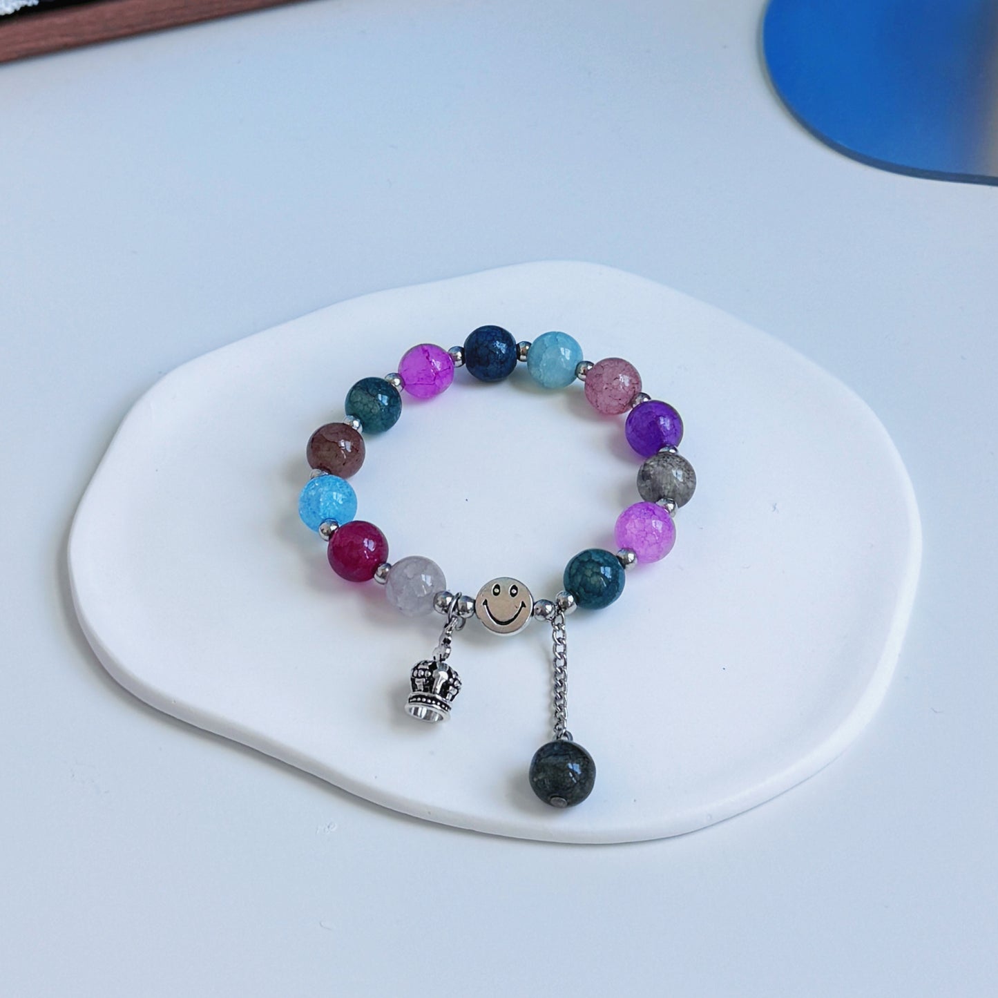 A cute, simple multicolored bracelet with bold colors resembling a artistic mosaic.