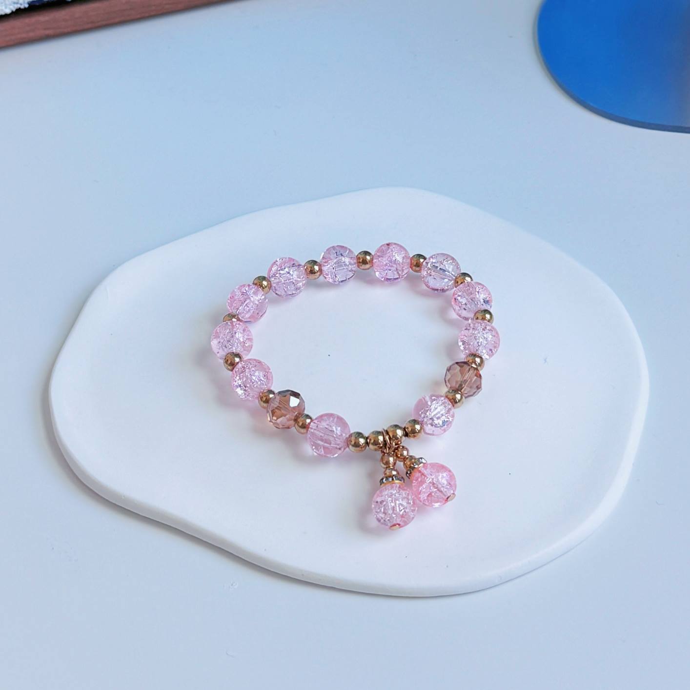 A simple, cute bracelet with light pink glass beads, a great addition to any fashionable outfit.