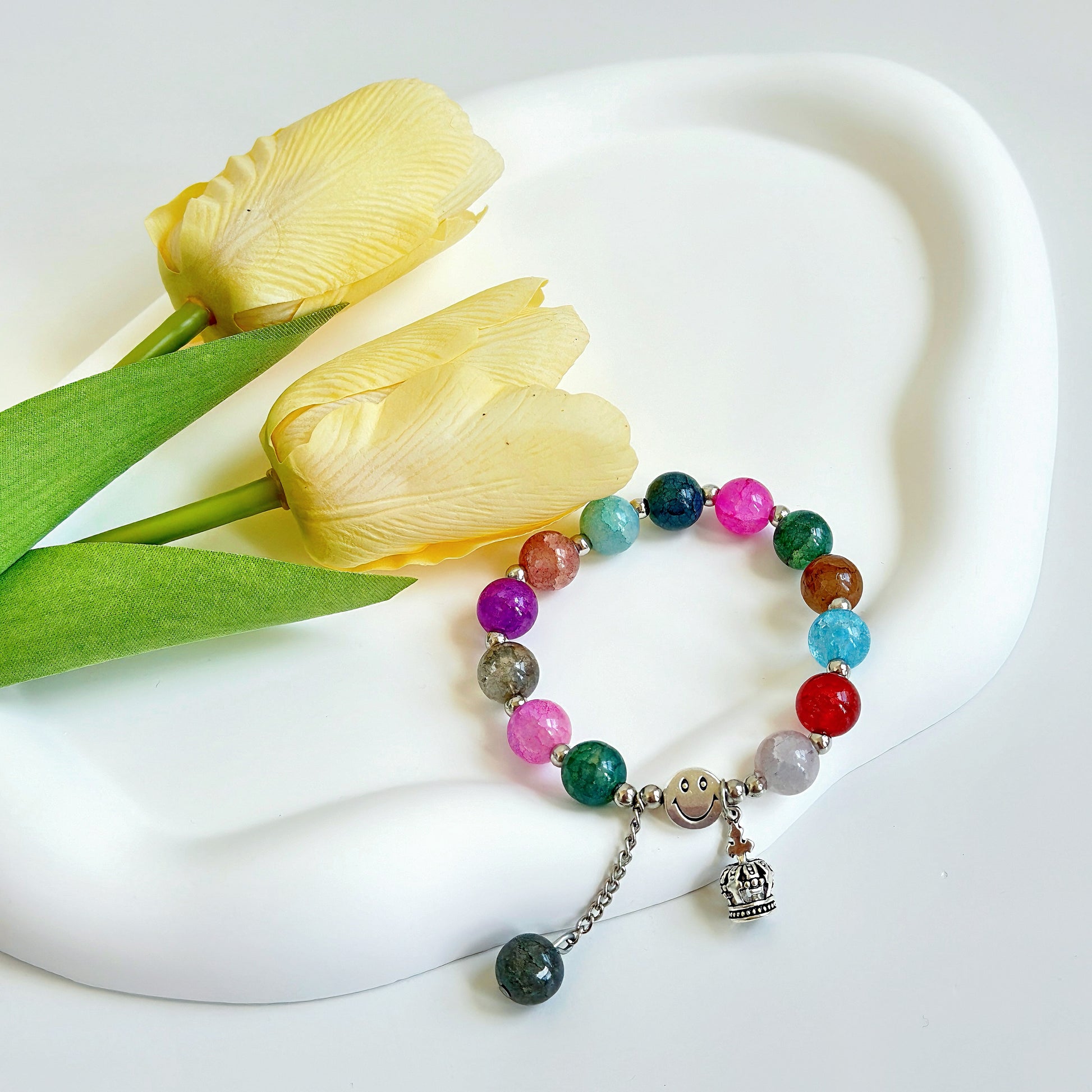 A delicate and pretty multi-colored bead bracelet, shiny and reflective.