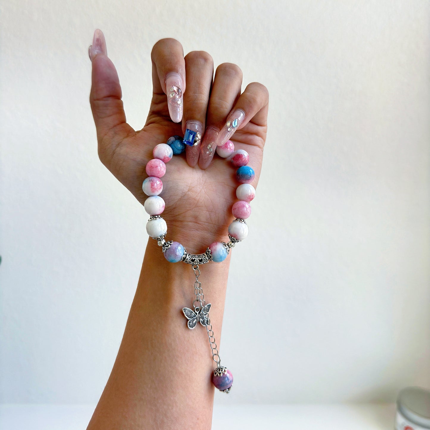 A simple, cute bracelet with pink, blue, and white glass beads, a perfect gift for her.